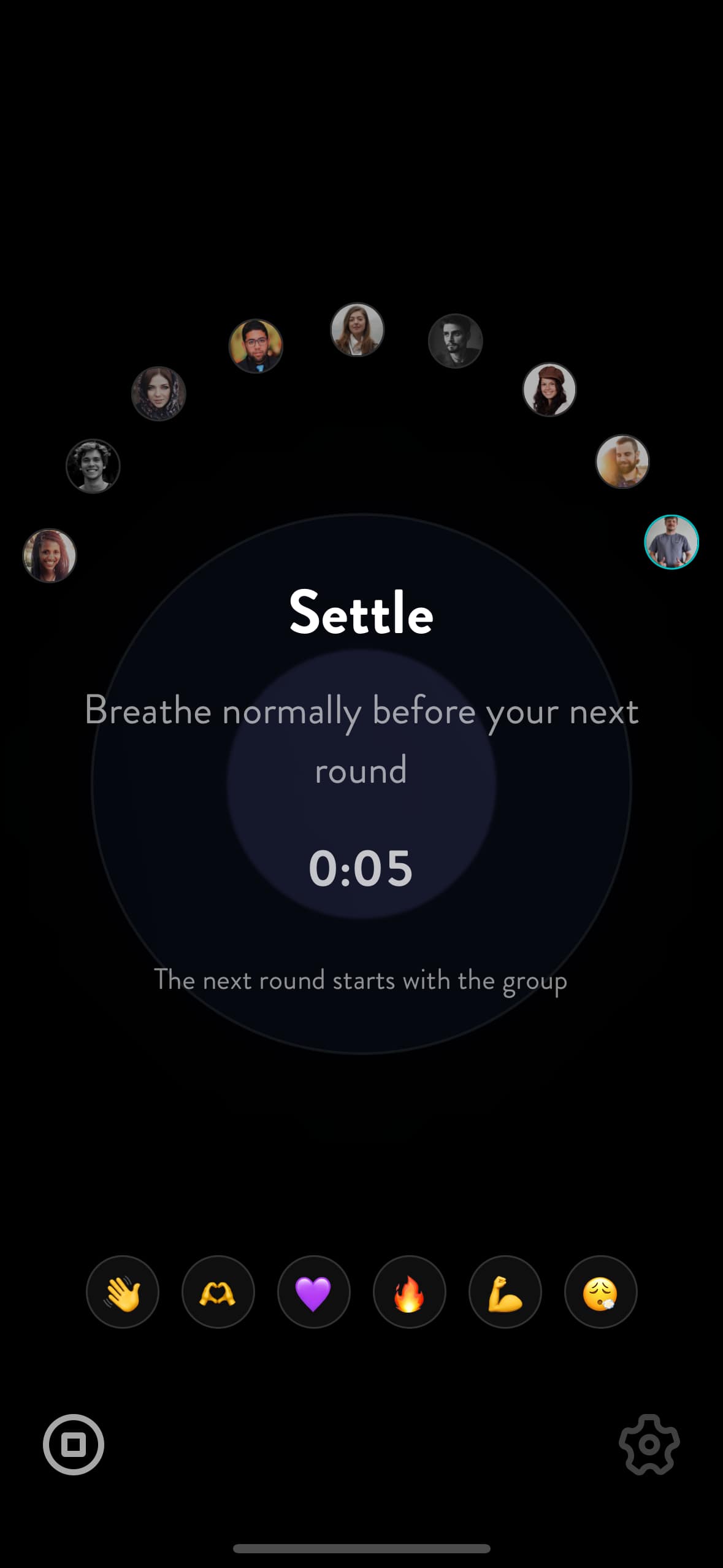 The settle screen between rounds — the room's faces arced around the breath circle