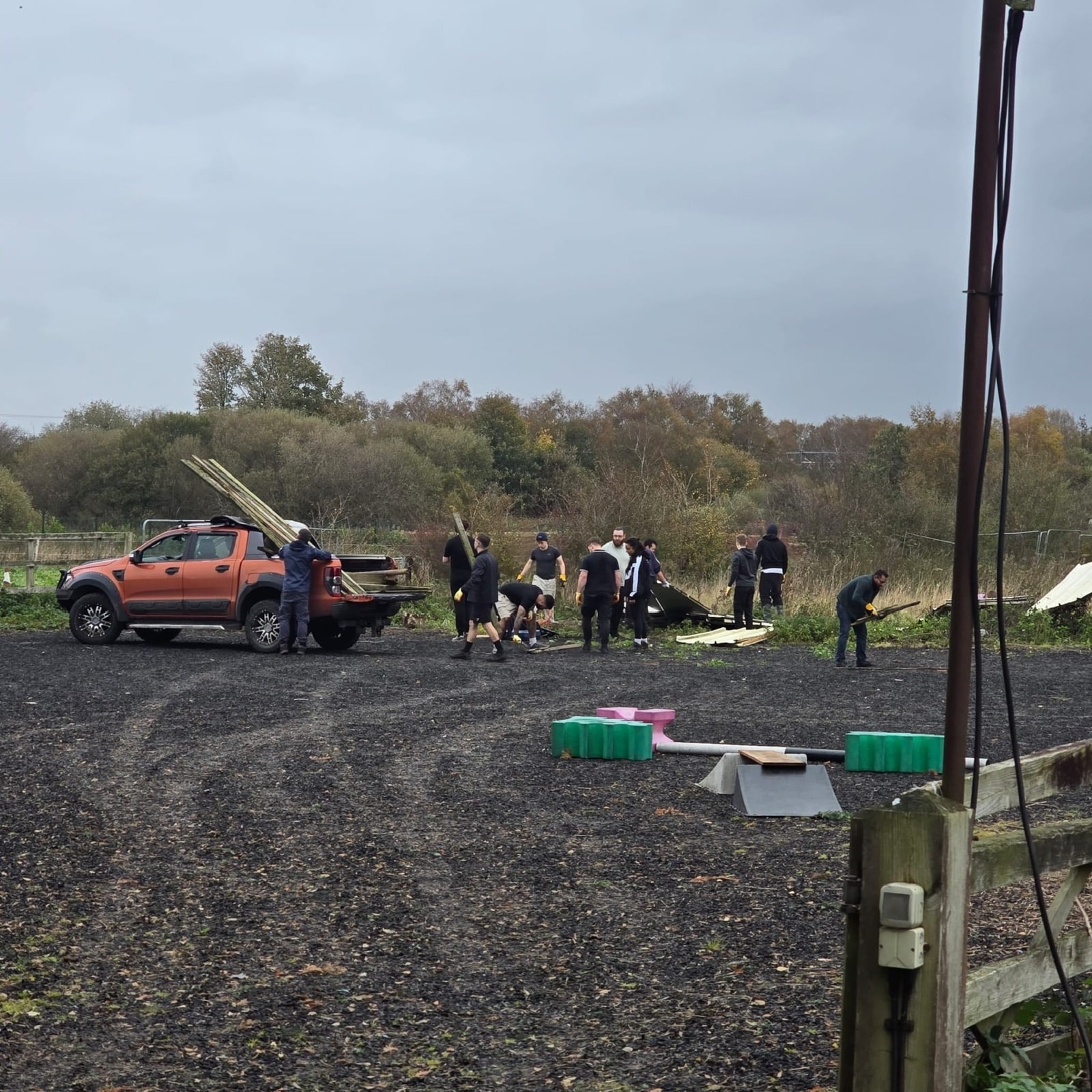 Volunteers loading old fencing and roofing sheets onto the pickup